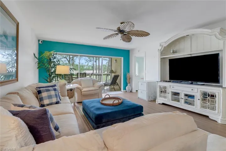 Living room with ceiling fan and wood finished floors