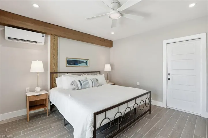Bedroom featuring wood finish floors, recessed lighting, and ceiling fan - Virtually Edited Image