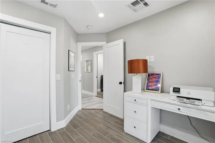 Unfurnished office with wood finish floors and baseboards - Virtually Edited Image