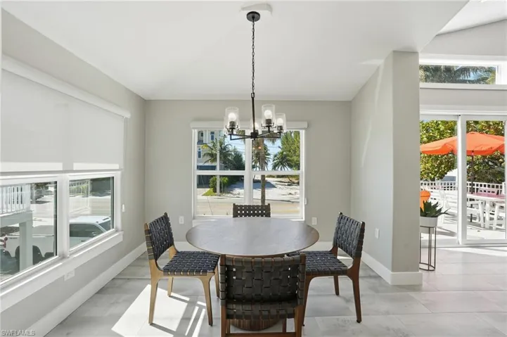 Dining room featuring suspended lighting and baseboards - Virtually Edited Image
