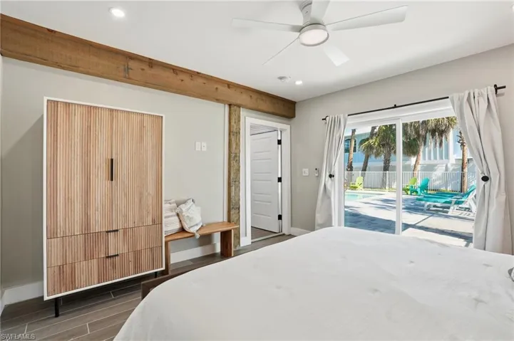 Bedroom with wood tiled floors, access to exterior, a ceiling fan, and recessed lighting - Virtually Edited Image