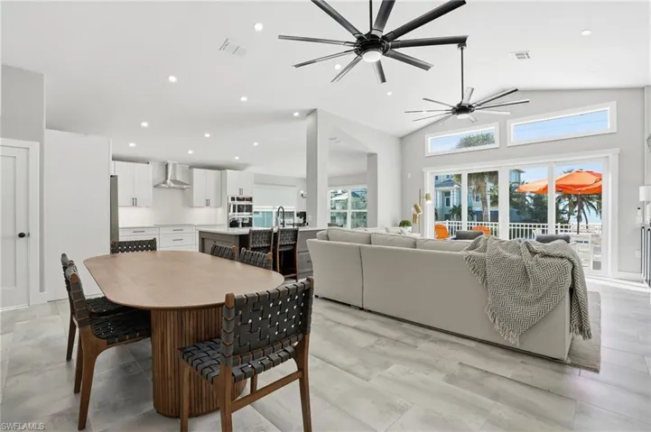 Dining area featuring recessed lighting, vaulted ceiling, and ceiling fan - Virtually Edited Image