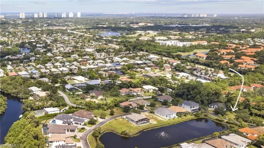 Birds eye view of property featuring a water view and a residential view