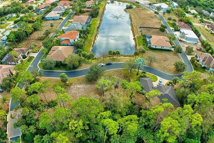 Aerial view featuring a water view and a residential view