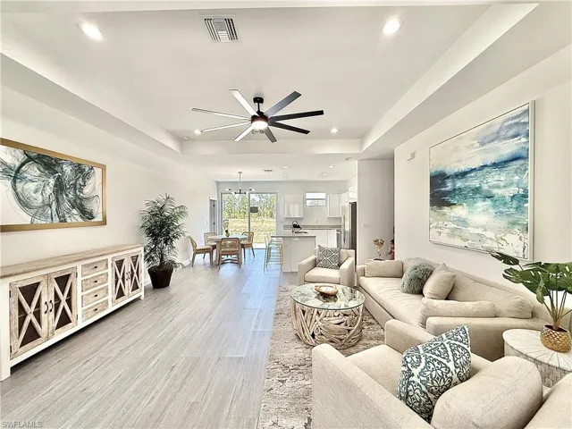 Living room featuring visible vents, ceiling fan, recessed lighting, and light wood-style floors