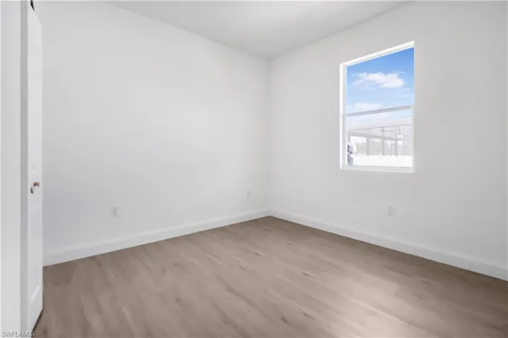 Empty room with baseboards and light wood-style floors