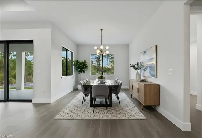 Spacious dining area featuring wood-finish flooring, a contemporary chandelier, and large windows