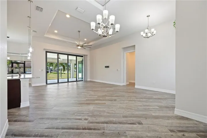Great Room with Volume Ceilings with Tray Accents & Diagonal Wood-Look Tile Floors