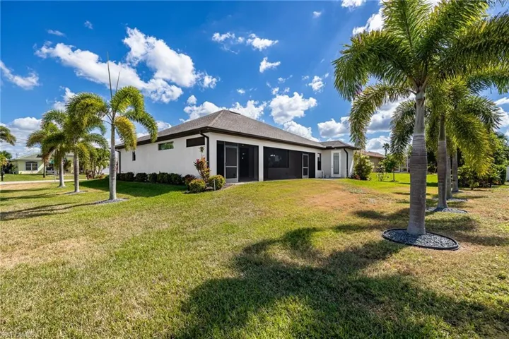 View of Back of Home Lined with Tropical Palm Trees