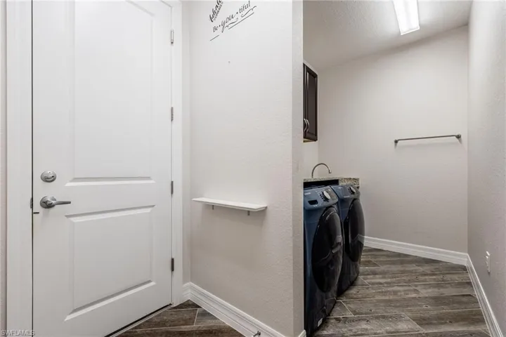 Convenient Laundry Room with Front Load Washer & Dryer