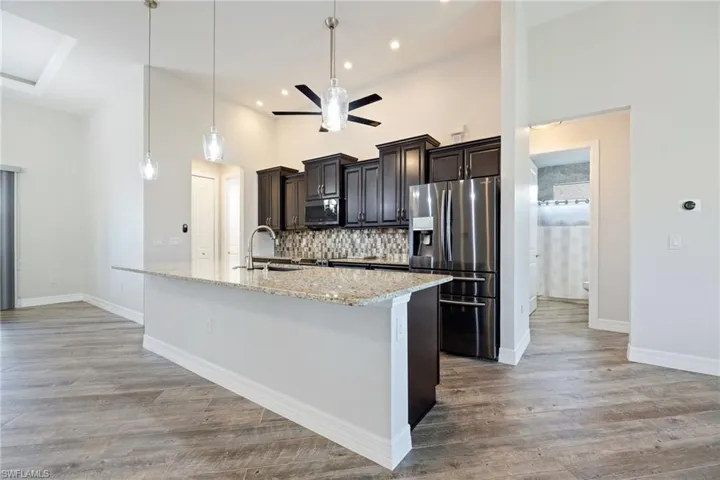 Kitchen Features a Large Island & Granite Countertops
