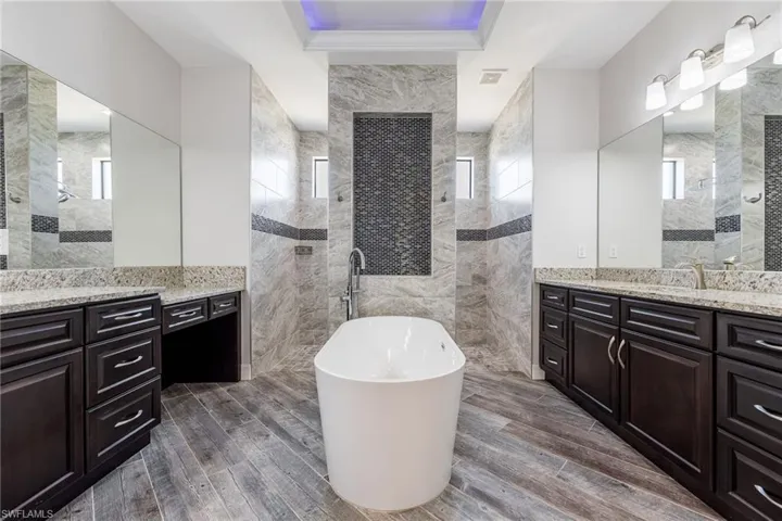 Primary Bathroom with Separate His & Her Sinks, A Soaker Tub & Walk-Around Shower