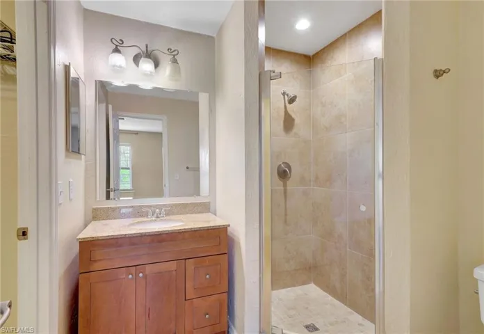 Bathroom with a shower stall and vanity