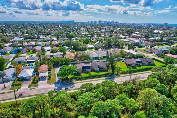 Aerial perspective of suburban area featuring city skyline