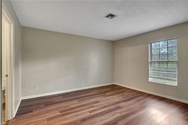 Primary bedroom featuring wood finished floors
