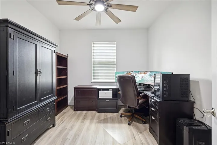 Office space featuring ceiling fan and light wood-type flooring