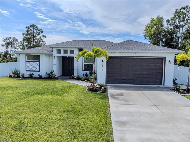 Single story home with a front lawn and a garage