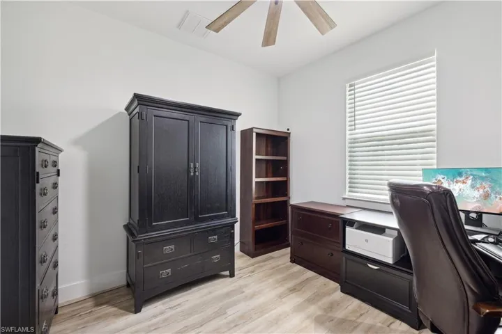 Office area featuring ceiling fan and light hardwood / wood-style floors