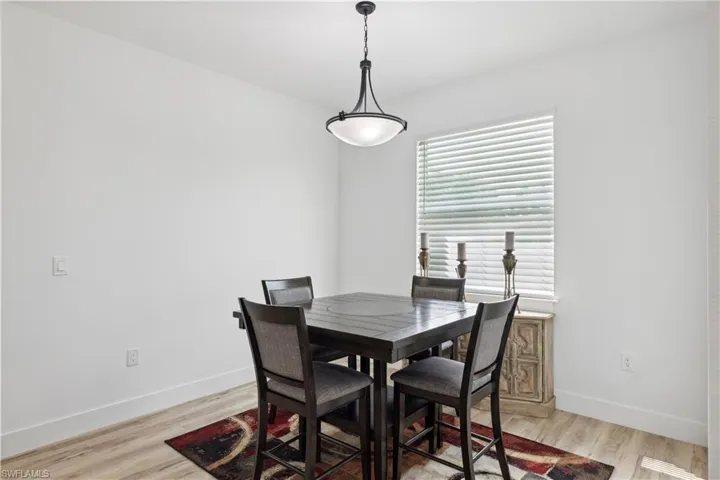 Dining space with light hardwood / wood-style floors
