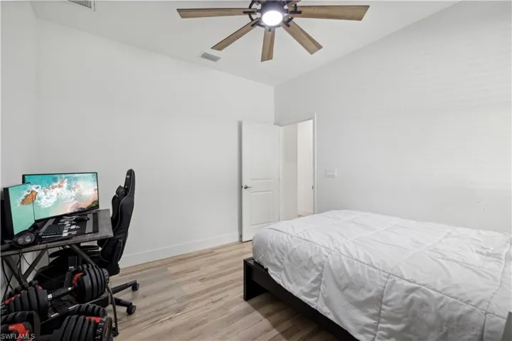 Bedroom featuring ceiling fan and light hardwood / wood-style flooring