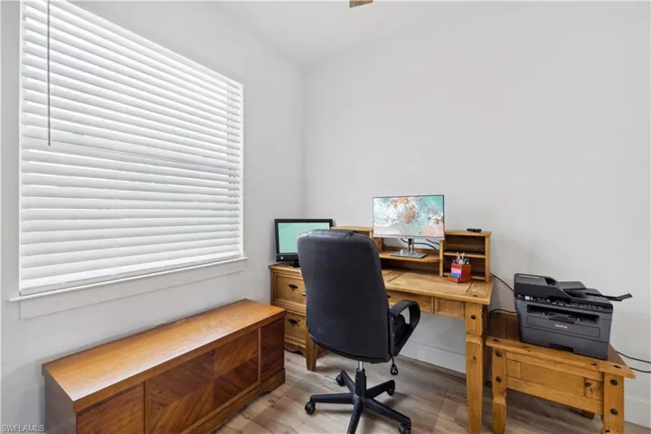 Office space with hardwood / wood-style flooring
