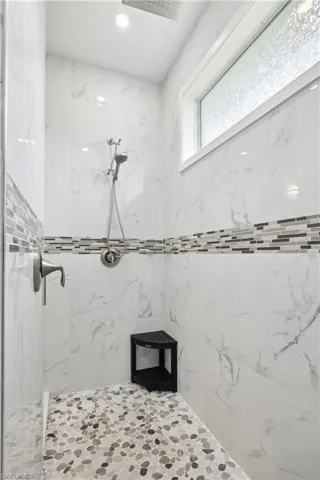 Bathroom featuring tiled shower