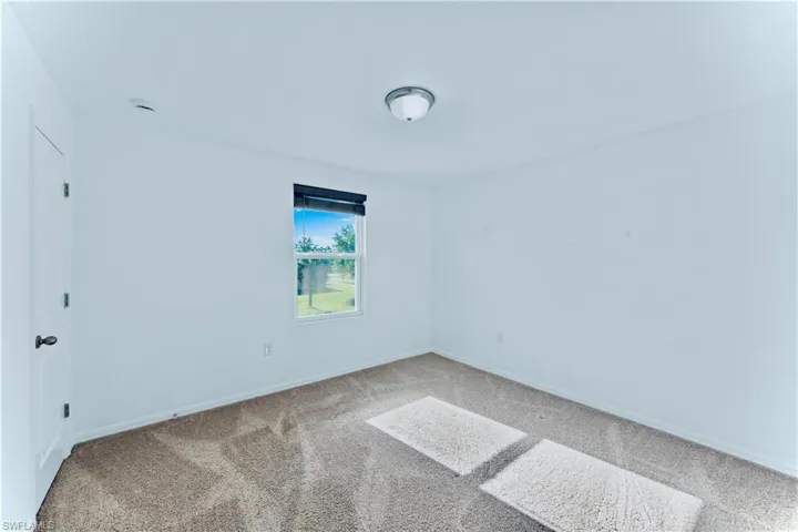 Spare room with baseboards and carpet floors