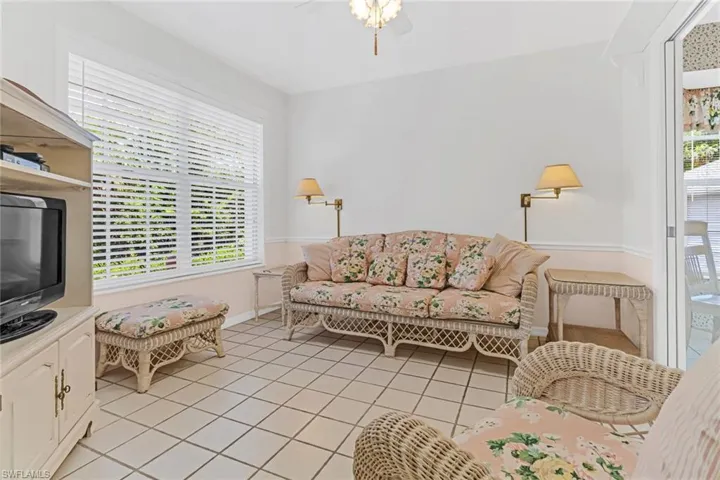 Tiled living room featuring a wealth of natural light and ceiling fan