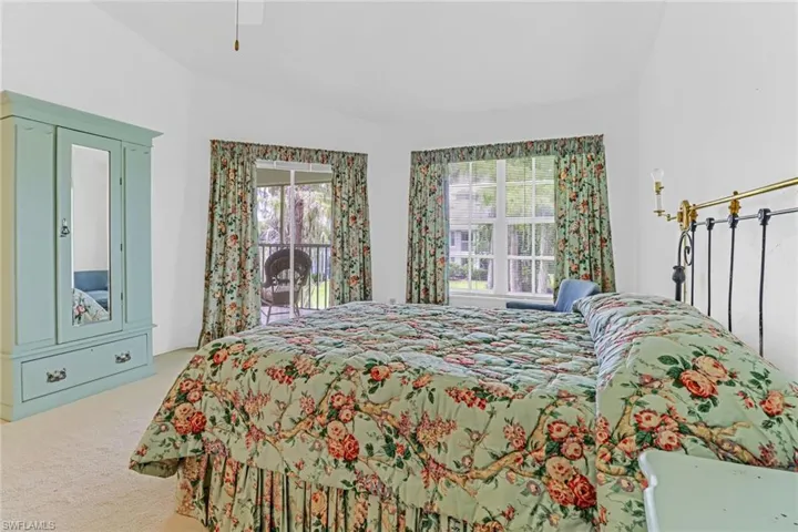 Bedroom with carpet flooring, vaulted ceiling, and ceiling fan