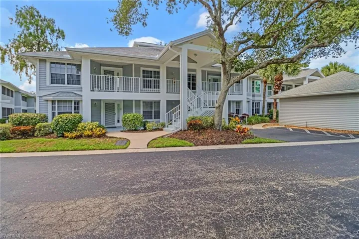 View of front of property with a balcony