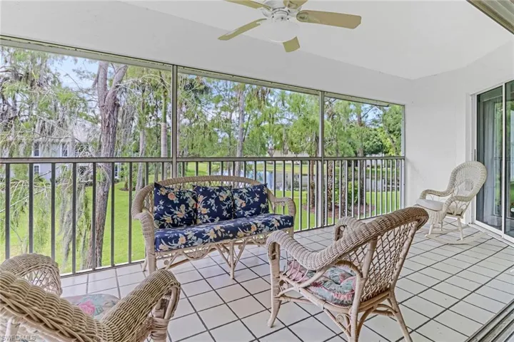 Sunroom / solarium featuring ceiling fan