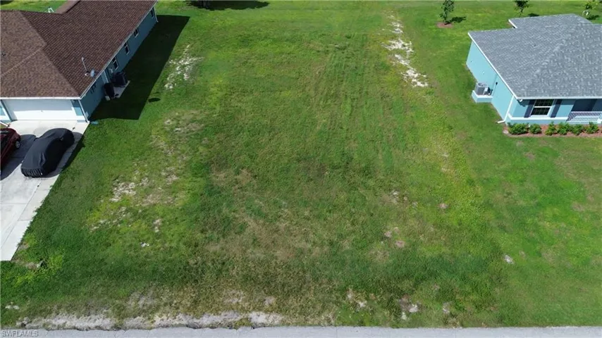 Expansive grass lot bordered by a paved road