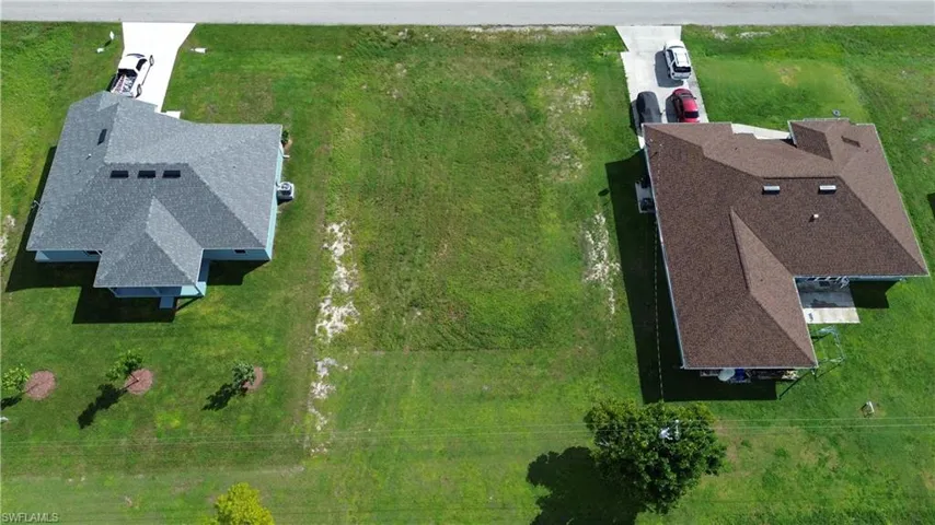 Expansive green lot with established grass, offering ample space for development