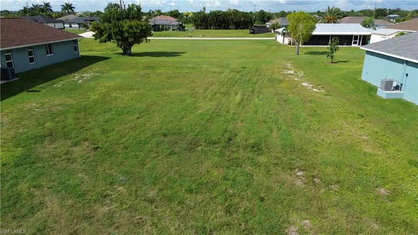 Expansive, undeveloped lot with a level, grassy terrain