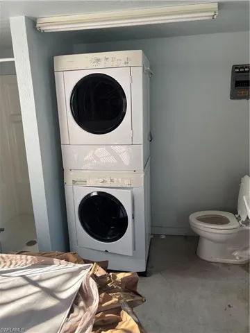 Laundry room featuring stacked washer and clothes dryer