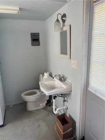 Bathroom featuring concrete flooring and a textured ceiling