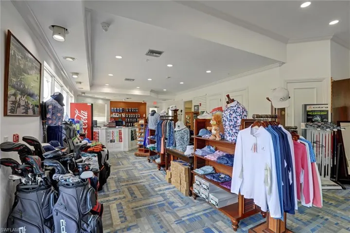 Spacious retail interior featuring recessed lighting, a decorative patterned carpet, a central counter with display shelving, and ample natural light from multiple windows