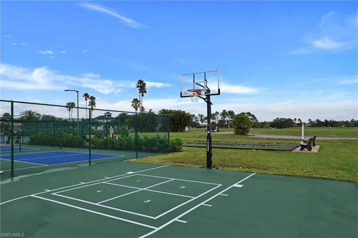Basketball court featuring a permanent hoop and clear backboard