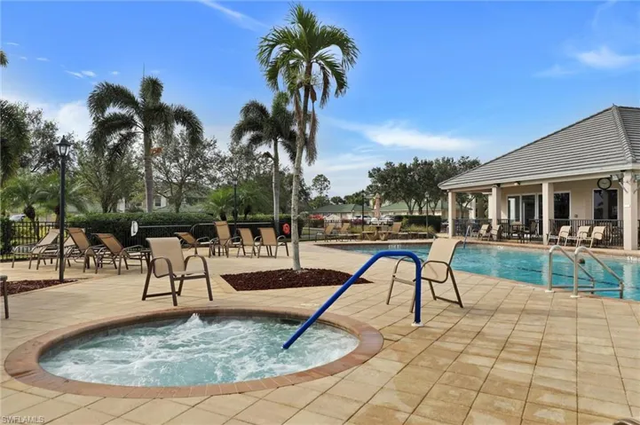 Outdoor spa with integrated seating, surrounded by a paver patio