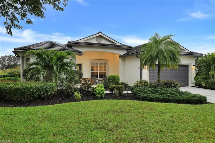 Single-story residence featuring a tile roof, stucco exterior, and an attached garage with a dark gray door