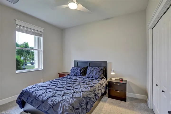 Bedroom featuring a double-hung window with blinds, ceiling fan, neutral wall paint, and carpet flooring