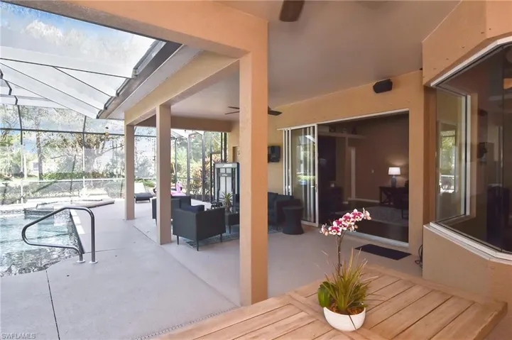 View of patio / terrace featuring a lanai, outdoor seating, a sunroom, and an outdoor pool
