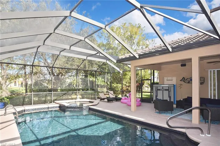 Integrated pool / hot tub featuring a patio, a sunroom, a lanai, and an outdoor lounge area