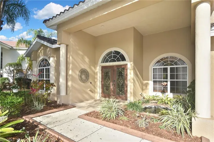 View of exterior entry with french doors and stucco siding