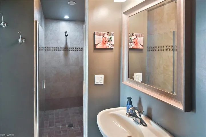Bathroom featuring a shower stall and recessed lighting