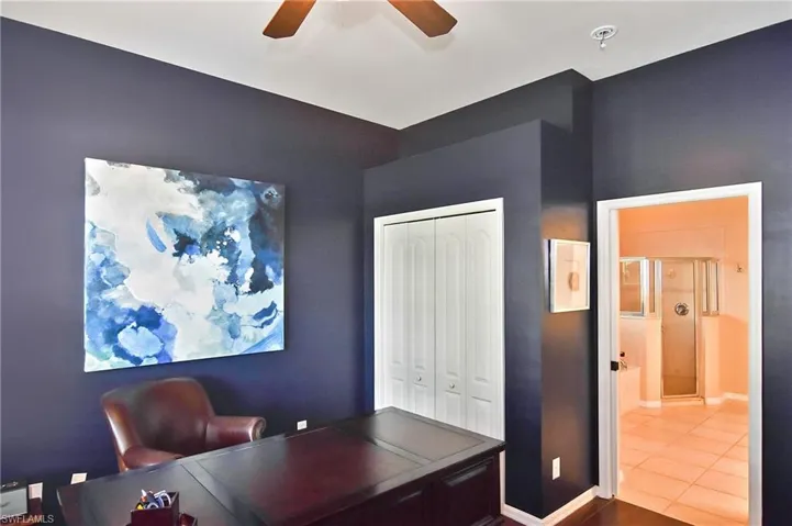 Office space featuring ceiling fan and baseboards