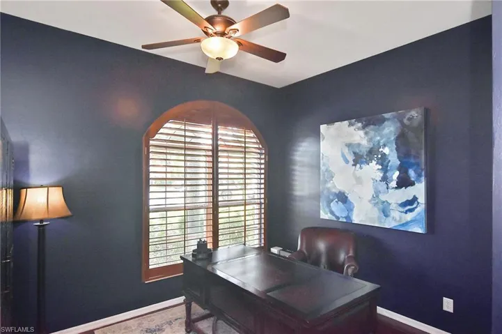 Office area with baseboards and a ceiling fan