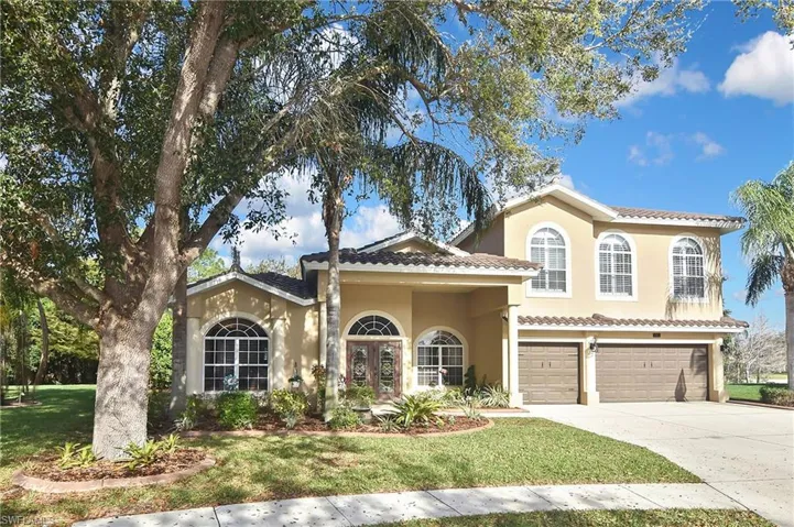 Mediterranean / spanish-style home with french doors, stucco siding, a garage, a front yard, and concrete driveway