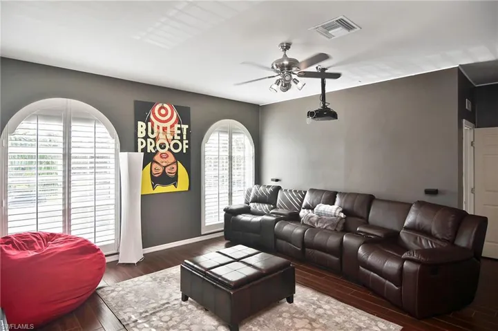 Living area with a ceiling fan and wood finished floors