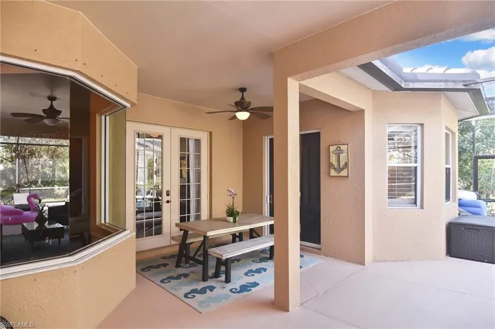 View of patio with a ceiling fan and french doors